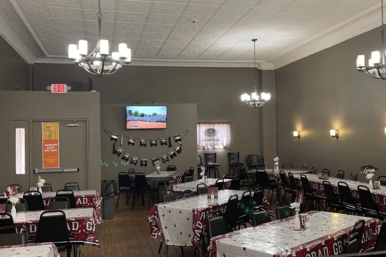 The room set up for a graduation party with decorated tables