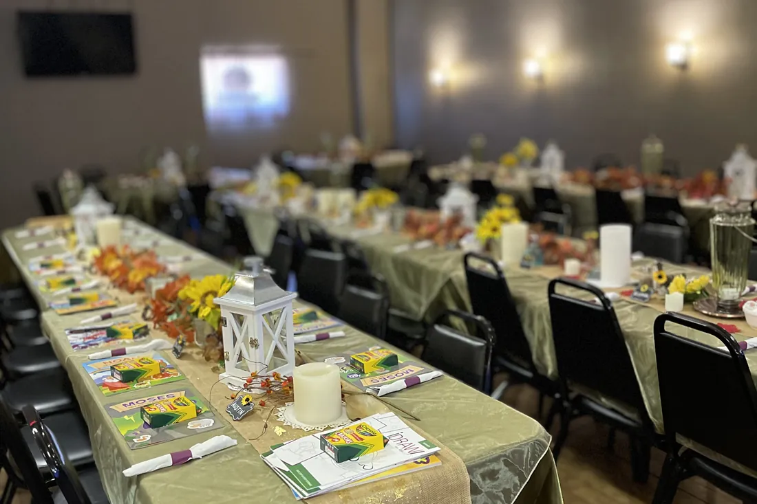 The dining room at Sally's set with long tables, linens and centrepieces for a private event