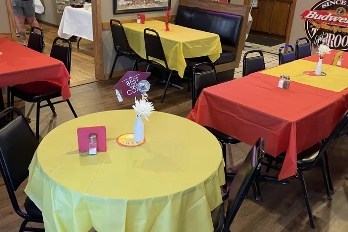 Round tables dressed in bright linens with centrepieces